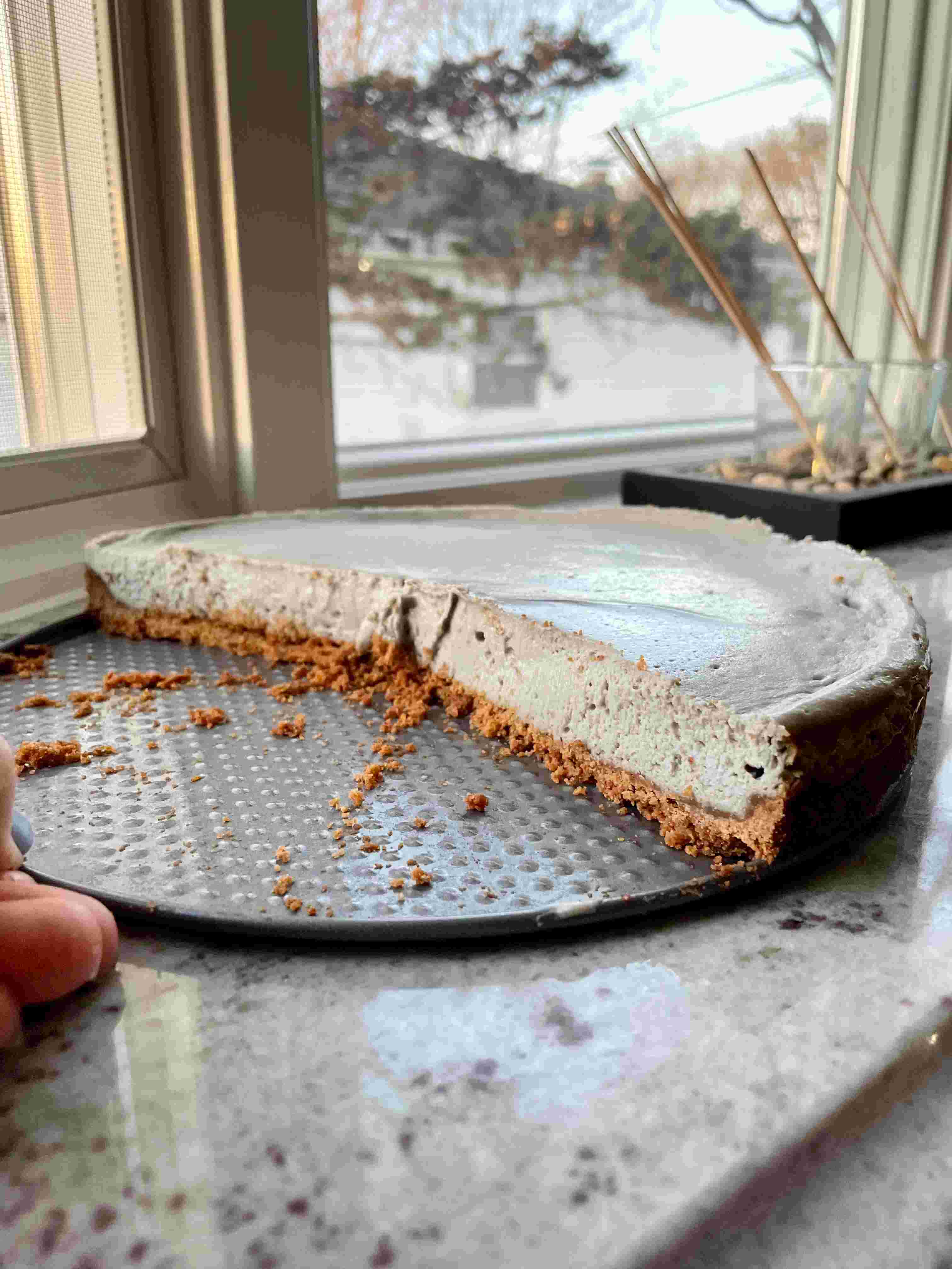 Black sesame cheesecake slice on plate