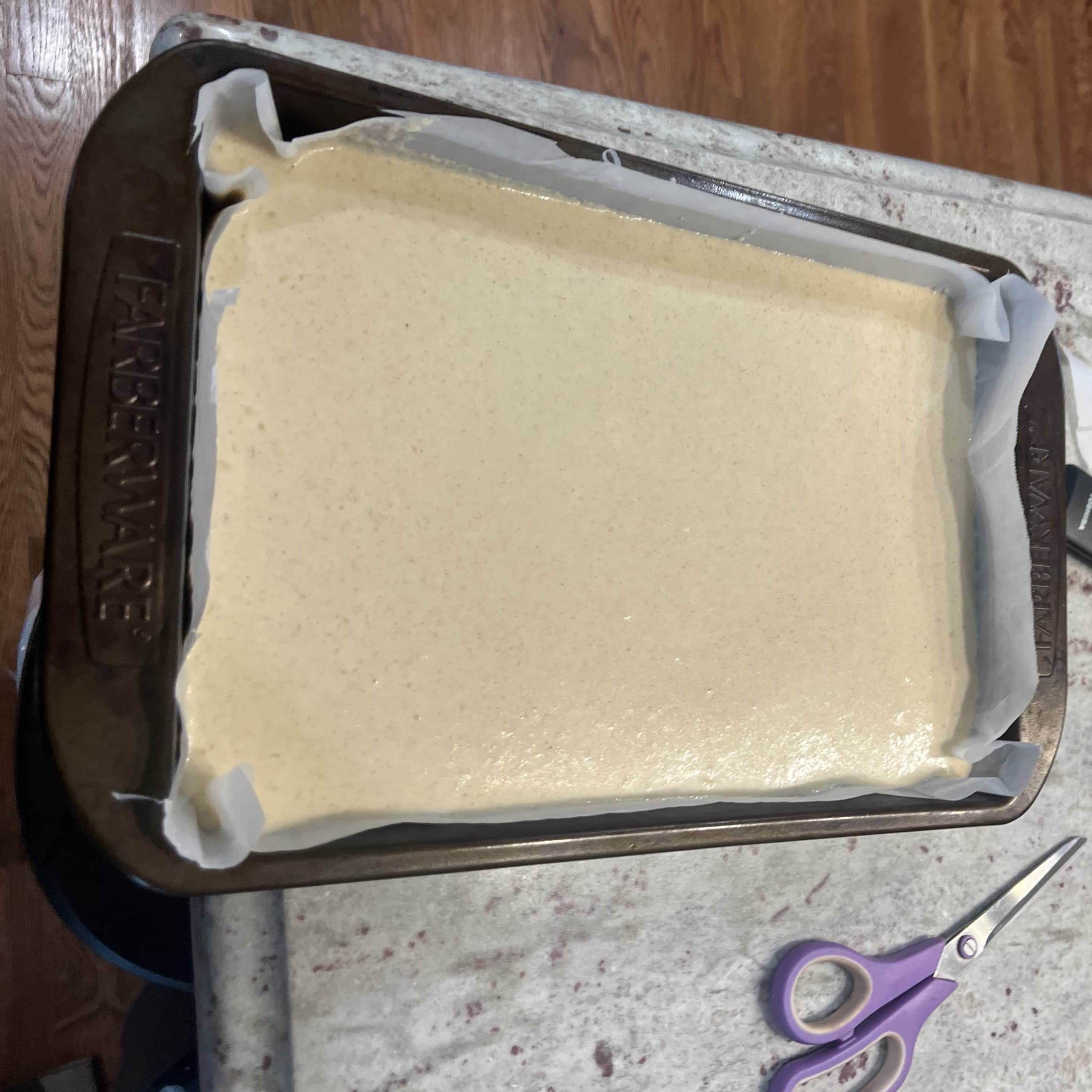 Cassava cake batter spread evenly in the pan before baking