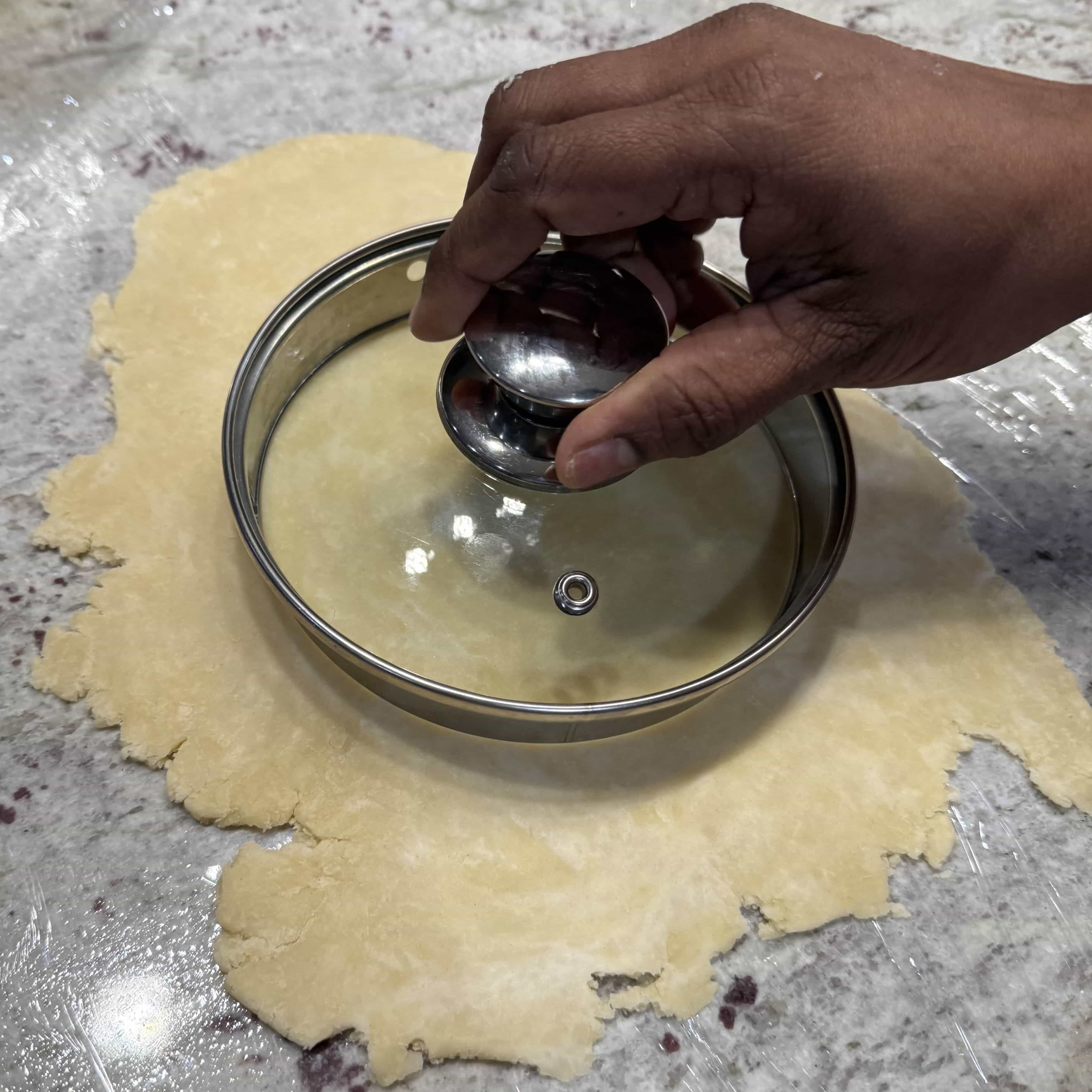 A six-inch pot lid used to cut round pastry pieces