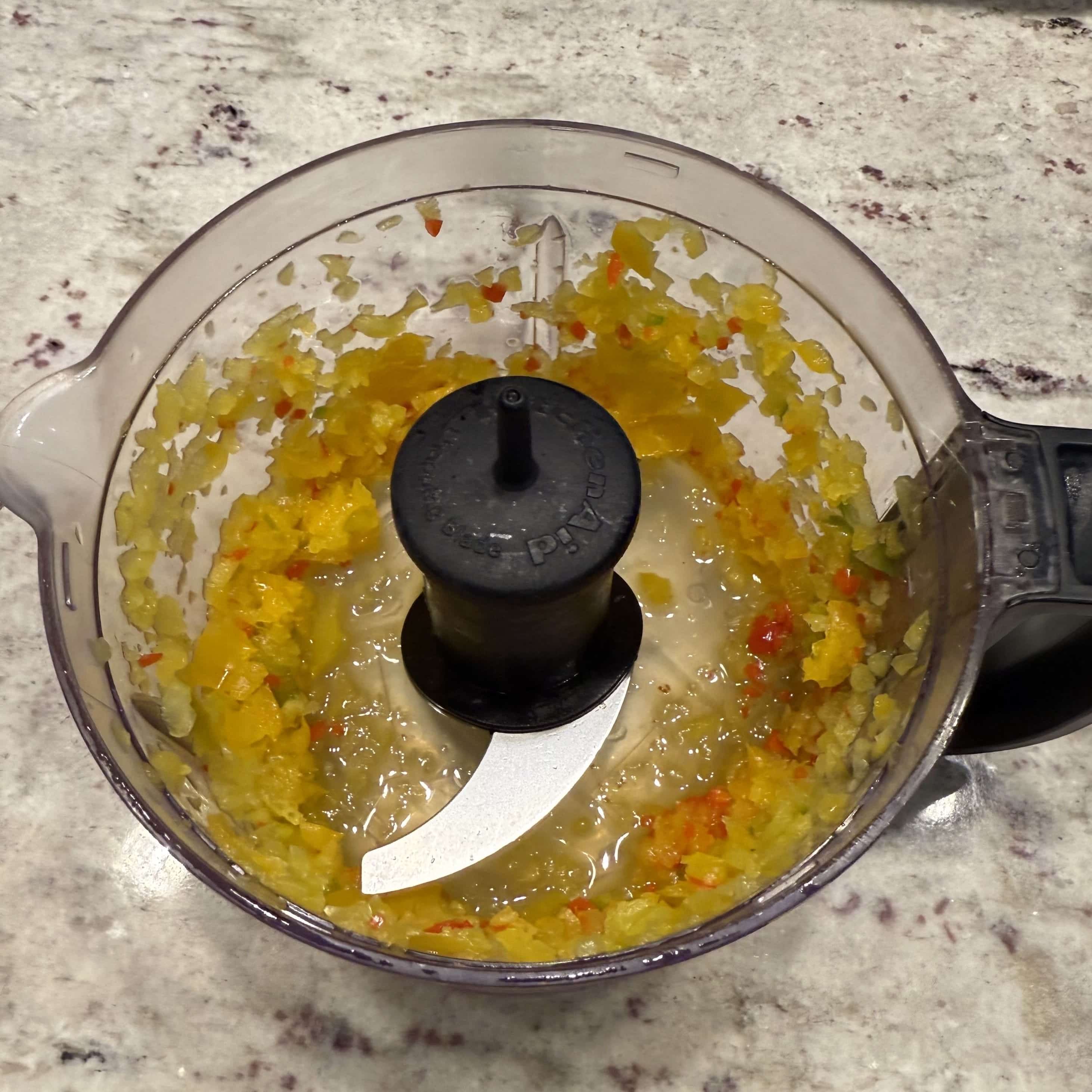 Bell peppers and wiri wiri peppers in food processor